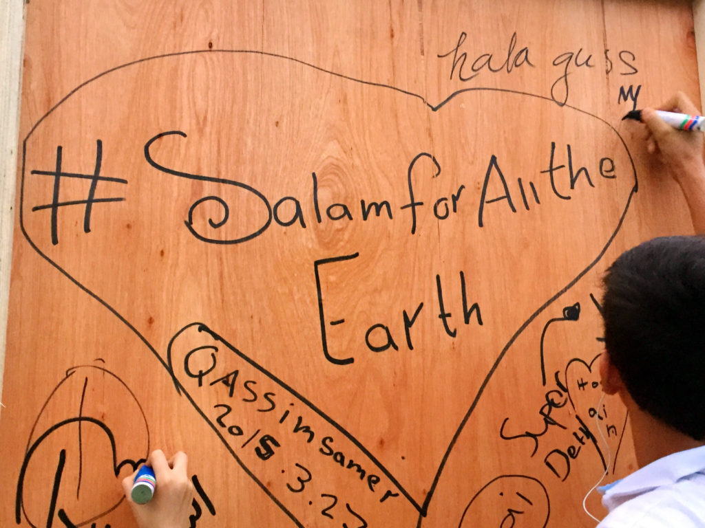 Children are seen scribbling messages of peace and tolerance on a big board, ahead of the “Salam Aleikum” peace concert at Zabeel Park on Friday evening.